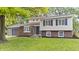 Charming two-story home featuring a brick and siding facade, well-maintained lawn and an attached garage at 1641 Whistler Terrace, Indianapolis, IN 46229