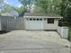 Detached one-car garage with concrete driveway and basketball hoop near a patterned concrete wall at 1641 Whistler Terrace, Indianapolis, IN 46229