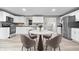 Modern kitchen with stainless steel appliances, white cabinets, and a round dining table with stylish chairs at 1641 Whistler Terrace, Indianapolis, IN 46229