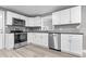 Bright kitchen featuring white cabinets, stainless steel appliances, granite countertops, and light wood floors at 1641 Whistler Terrace, Indianapolis, IN 46229