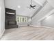 Bright living room with vaulted ceilings, a black stone fireplace and light wood floors at 1641 Whistler Terrace, Indianapolis, IN 46229