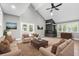 Bright living room with vaulted ceilings, a stone fireplace, neutral furniture, and light wood floors at 1641 Whistler Terrace, Indianapolis, IN 46229