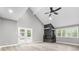 Bright living room with vaulted ceilings, a black stone fireplace and light wood floors at 1641 Whistler Terrace, Indianapolis, IN 46229