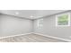 Well-lit room with grey walls, light colored floors, and two windows at 1641 Whistler Terrace, Indianapolis, IN 46229