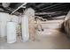 Unfinished basement with exposed pipes, brick support column, and two water heaters at 1822 N Dexter St, Indianapolis, IN 46202