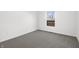Empty bedroom featuring neutral carpet, a window, and electrical outlets at 1822 N Dexter St, Indianapolis, IN 46202