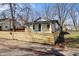 A charming home is showcased by a new wooden fence and landscaping at 1822 N Dexter St, Indianapolis, IN 46202