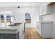Bright kitchen offers stainless sink, granite counters, and a view to the neighborhood at 1822 N Dexter St, Indianapolis, IN 46202