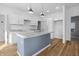 New kitchen boasts stainless appliances, shaker cabinets, and granite countertops on an island at 1822 N Dexter St, Indianapolis, IN 46202