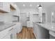 Kitchen featuring stainless appliances, white shaker cabinets, and granite countertops at 1822 N Dexter St, Indianapolis, IN 46202