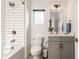 Bathroom with white subway tile, gray vanity and a window for natural light at 1955 Alvord St, Indianapolis, IN 46202