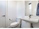 Simple half bath with pedestal sink, white fixtures, and neutral walls at 1955 Alvord St, Indianapolis, IN 46202