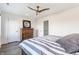 Relaxing bedroom featuring dark wood floors, ceiling fan, neutral colors, and a large decorative dresser at 1955 Alvord St, Indianapolis, IN 46202