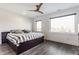 Cozy bedroom with dark wood floors, ceiling fan, and large windows for natural light at 1955 Alvord St, Indianapolis, IN 46202
