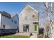 Exterior side view with gray siding, sliding glass door, and a pop of color with a green door at 1955 Alvord St, Indianapolis, IN 46202