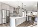 Spacious modern kitchen with stainless steel appliances, gray cabinets, large island, and wood floors at 1955 Alvord St, Indianapolis, IN 46202