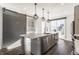 Modern kitchen featuring stainless steel appliances, quartz countertops and sliding barn door at 1955 Alvord St, Indianapolis, IN 46202