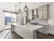 Contemporary kitchen with stainless steel appliances, gray cabinetry, and an island with quartz countertop at 1955 Alvord St, Indianapolis, IN 46202