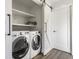 Bright laundry room features a sliding barn door and modern washer and dryer units at 1955 Alvord St, Indianapolis, IN 46202