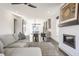 Open-concept living space featuring a gray sectional sofa, dining table, fireplace, and stylish decor at 1955 Alvord St, Indianapolis, IN 46202