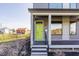 Inviting porch with a vibrant green door, complemented by dark trim, modern windows, and easy access at 1955 Alvord St, Indianapolis, IN 46202