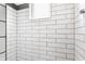 Tiled shower with white subway tiles, tiled floor, and window at 1955 Alvord St, Indianapolis, IN 46202