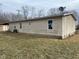 Side view of a tan single-story home with new vinyl windows at 209 Crawford St, Clayton, IN 46118