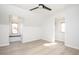 Airy bedroom featuring multiple windows, light gray walls, and sleek ceiling fan at 249 N Hamilton Ave, Indianapolis, IN 46201