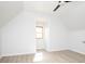 Slanted ceiling bedroom with light-colored wood floors, and lots of natural light from the window at 249 N Hamilton Ave, Indianapolis, IN 46201