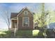 Charming brown house with a gabled roof, light trim, and a welcoming front porch at 249 N Hamilton Ave, Indianapolis, IN 46201