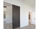 Hallway with sliding barn door and views of kitchen and bath at 249 N Hamilton Ave, Indianapolis, IN 46201