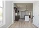 Open-concept kitchen with dark cabinetry, butcher block countertops, stainless steel sink, and natural light at 249 N Hamilton Ave, Indianapolis, IN 46201