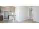 Open-concept living room showcases light-colored wood flooring, chandelier lighting, and seamless flow to the kitchen at 249 N Hamilton Ave, Indianapolis, IN 46201