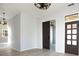 Bright, open living room with light-colored wood flooring, sliding barn door, and windows offering natural light at 249 N Hamilton Ave, Indianapolis, IN 46201