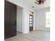Living area featuring a sliding barn door, large window, and multi-paneled front door at 249 N Hamilton Ave, Indianapolis, IN 46201