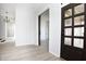 Bright, open-concept living room with modern flooring and views of a sliding barn door at 249 N Hamilton Ave, Indianapolis, IN 46201