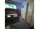 Bedroom with bunk beds, hardwood floors, a bicycle, and a blue neon clock on the wall at 2820 N Gladstone Ave, Indianapolis, IN 46218