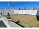 Spacious backyard featuring manicured lawn, surrounded by pristine white fence, and decorative outdoor lamps at 32 E Main St, Mooresville, IN 46158