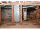 Basement features exposed brick and wooden support beams and mechanical equipment at 32 E Main St, Mooresville, IN 46158