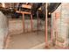 Unfinished basement featuring exposed brick and structural support beams at 32 E Main St, Mooresville, IN 46158