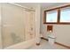 Well-maintained bathroom with tiled floor, shower-tub, and ample lighting at 32 E Main St, Mooresville, IN 46158
