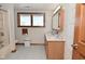 Bathroom features double vanity, linoleum flooring, and a shower-tub combo with a window at 32 E Main St, Mooresville, IN 46158