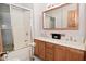 This bathroom features a double vanity, a shower and tub combo with sliding doors at 32 E Main St, Mooresville, IN 46158