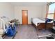 Well-lit bedroom featuring hospital bed, medical equipment, and comfortable seating at 32 E Main St, Mooresville, IN 46158