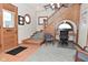 Bright entryway showcases an elegant wooden staircase with adjacent desk space at 32 E Main St, Mooresville, IN 46158