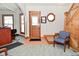 Cozy entryway boasts wood accents, a staircase, and a comfortable seating area at 32 E Main St, Mooresville, IN 46158