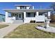 Charming home with a covered front porch, white painted brick facade, and landscaped front yard at 32 E Main St, Mooresville, IN 46158