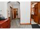 Hallway features hardwood trim and doors leading to a bathroom and the home's kitchen at 32 E Main St, Mooresville, IN 46158