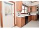 Bright kitchen featuring wood cabinetry, neutral countertops and view of the home's exterior at 32 E Main St, Mooresville, IN 46158