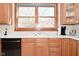 Kitchen featuring oak cabinets, countertops, sink, and a window at 32 E Main St, Mooresville, IN 46158